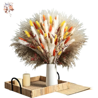 Bouquet of dried flowers in a white vase on a wooden tray with a light blue background