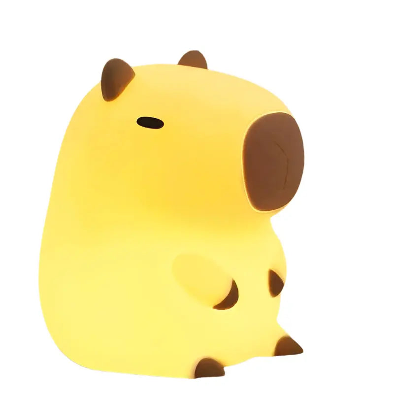 Cute animal-shaped night light on a wooden surface with a warm yellow background
