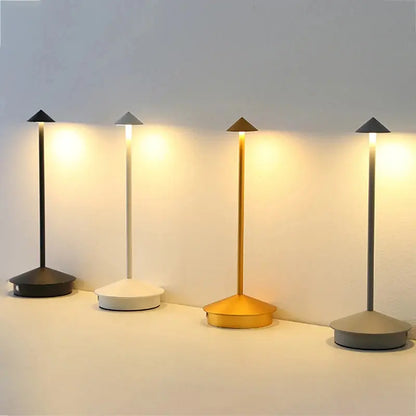 Four modern floor lamps with different base colors on a light gray background