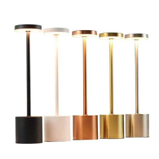 Set of five standing lamps in black, white, bronze, gold, and silver on a neutral background