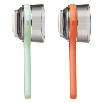 Multifunctional Vegetable peeler in mint green and orange with a clear storage box, perfect for peeling and slicing.