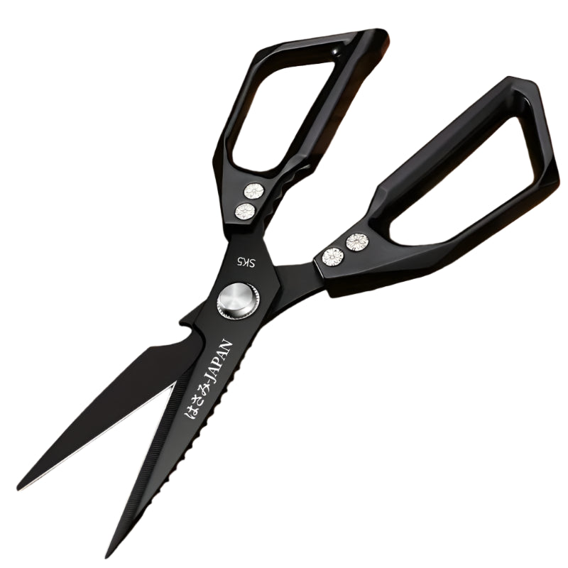 Black kitchen shears on a wooden surface with a fish, lemon, and broccoli.