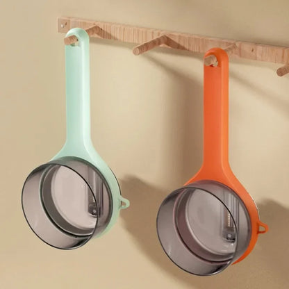 Multifunctional Vegetable peeler shown in mint green and orange colors, hanging on a wooden rack.