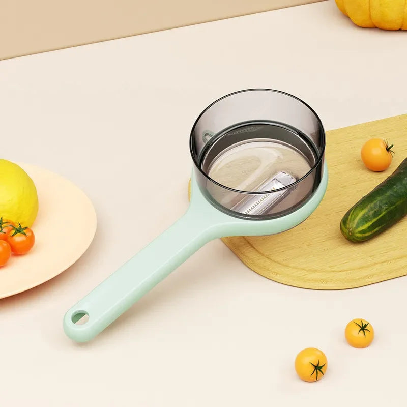 Multifunctional Vegetable peeler with storage box on a kitchen counter with fruits and vegetables.