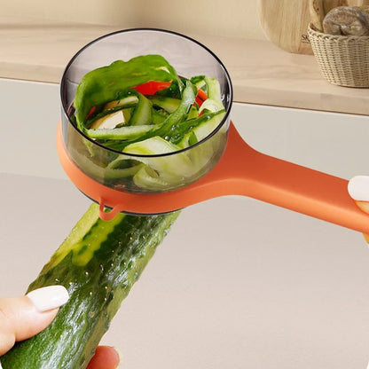 Orange vegetable peeler with a clear container filled with sliced vegetables on a light background